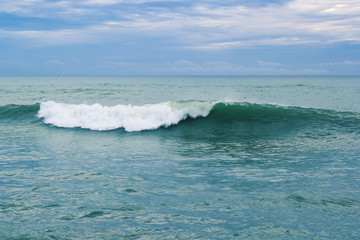 Blue ocean waves breaking on a stormy day natural background