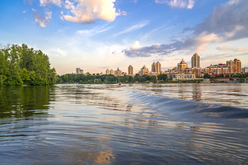 Fototapeta na wymiar Kiev, Ukraine - July 13, 2018 - Kyiv Obolon embankment. View from water of Dnieper river.