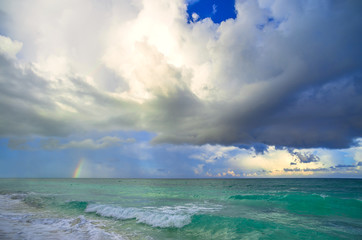 Big storm clouds in sky above blue sea