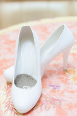 Wedding white female shoes on a blurry background