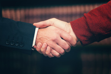 Handshake closeup in a lawyer's studio