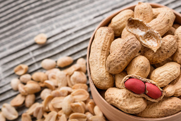 fresh peanuts on a wooden rustic background