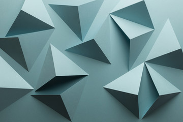 Composition with triangular shapes of paper, blue background