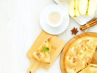 Breakfast with coffee, apple pie and apple on wooden white background, top view, empty space