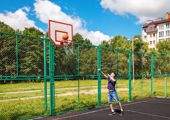 young man playing basketball outdoor