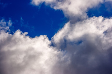 dense and great white clouds on a beautiful summer blue sky