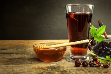 Home-made rosehip tea. Traditional cure for colds and flu. Dried berry on a wooden table. Hot rosehip tea. Winter tea.
