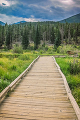 Fototapeta na wymiar Wooden Boardwalk near Sprague Lake in Rocky Mountain National Park, Colorado