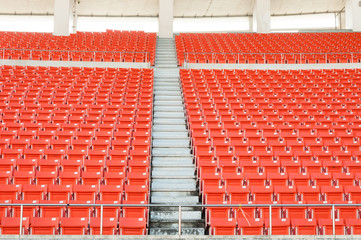 Naklejka premium Empty orange seats at stadium,Rows walkway of seat on a soccer stadium