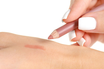Pencil for lips in hand on white background isolation