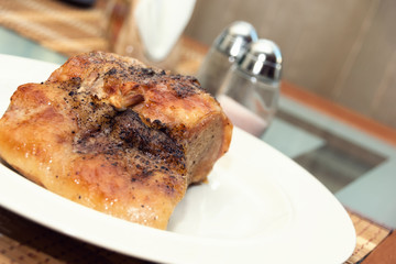 Pork steak on a white plate