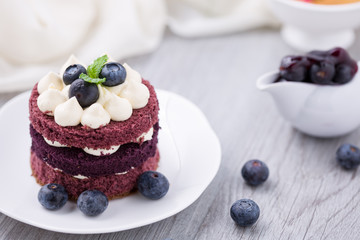 Blueberry cheesecake on white plate on wooden table, birthday party, corporate event or wedding celebration