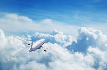 Fototapeta na wymiar Commercial airplane flying above clouds