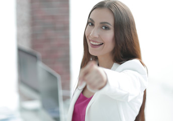confident business woman pointing finger forward