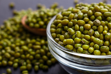 fresh Mung beans on a dark stone background