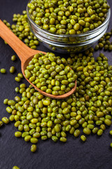 fresh Mung beans on a dark stone background