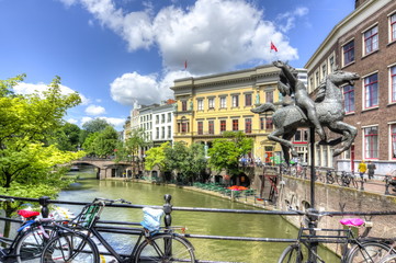 Girl on horse carousel monument and Utrecht canals, Netherlands