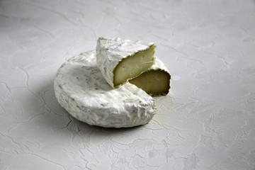 Ripe cut cheese camembert or brie brie on a cracked table