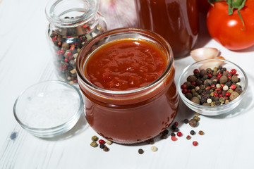 Products made with fresh tomato - sauce, juice and seasonings on white table, top view