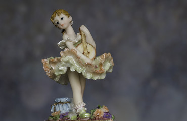Vintage Girl Figurine playing music wearing petticoat