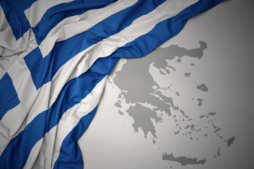 waving colorful national flag and map of greece. © luzitanija