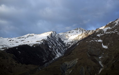 Fototapeta na wymiar Georgia. Caucasian mountains. Rocks, snow, clouds.