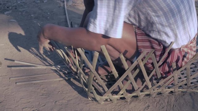 Weaving baby cradle with bamboo laths ( extreme close up)