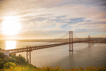 25th of April Bridge while beautiful sunset in Lisbon, Portugal
