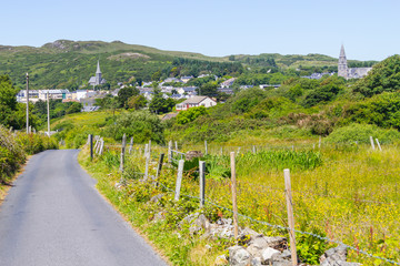Church, city, mountains and vegetation in Clifden