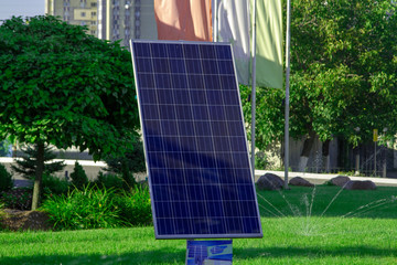 Solar panel on a green lawn. Solar panel near the residential quarter. Solar power from the electrical panel.