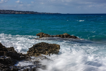Mediterranean landscape, windy day and the waves beating against the shore creating a white foam