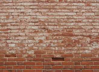 Old red brick wall texture background with peeled white plaster.