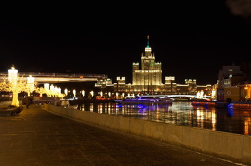 Fototapeta na wymiar Christmas illuminations on Moskvoretskaya embankment. High-rise building on Kotelnicheskaya embankment, Moscow, Russia