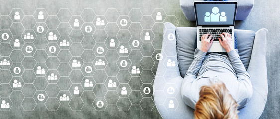 Human resources concept with man using a laptop in a modern gray chair