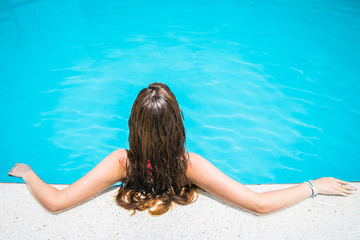 a blonde girl in a pool