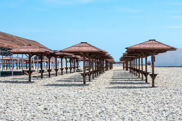 Wooden umbrellas on the beach