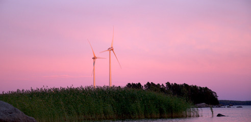 Wind turbines at sunset in Scandinavia Finland.