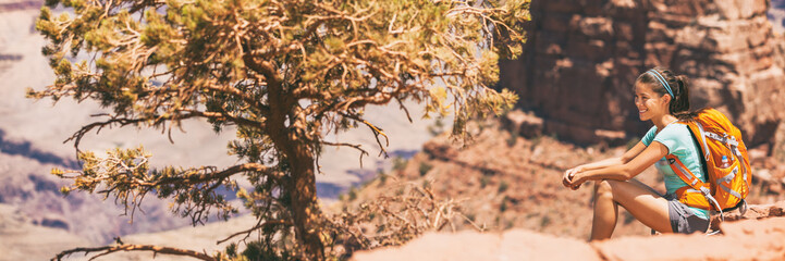 Hiker girl hiking on desert hike trail banner panoramic crop of landscape for copy space. Asian...