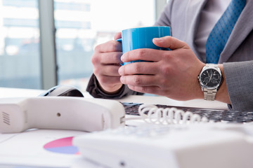 Businessman drinking coffee in the office