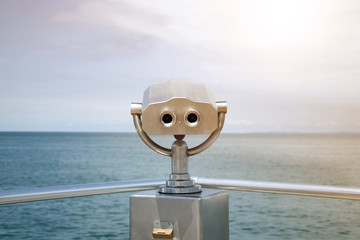 Binoculars, view of the sea and clouds