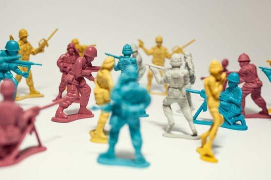 macro group of plastic toy soldiers making war