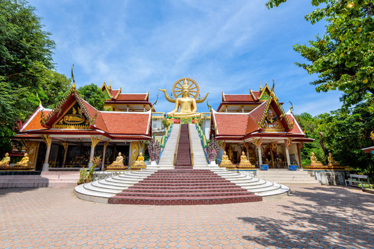 Large gold buddha statue in a sitting position under the blue sky at Big Buddha Temple is a famous tourist destination of Koh Samui island, Surat Thani province, Thailand