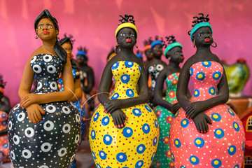 Little clay woman sculptures painted with vibrant colors and used as home decoration in the Northeast of Brazil in Olinda and Recife, Pernambuco, Brazil.