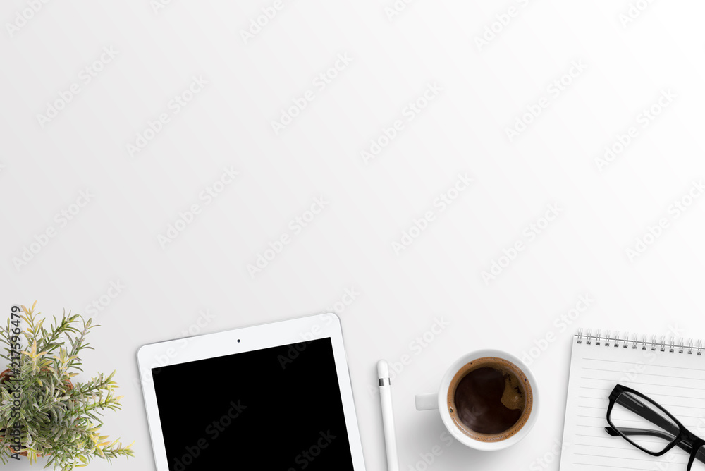 Poster Designer work space with tablet, notepad and cup of coffee. Free sapce for text above. Flat lay composition.