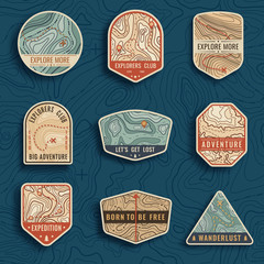 Set of nine topographic map travel emblems. Outdoor adventure emblems, badges and logo patches. Forest camp labels in vintage style. Map pattern with mountain texture and grid © barmaleeva