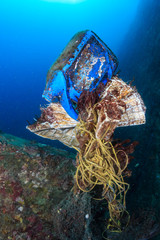 A mess of discarded plastic and fishing nets entangled on a tropical coral reef