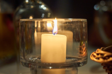 Candle on a table with blurred background bokeh.