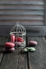 Group of macarons made of strawberries, cream, chocolate and blueberries. Rustic photo.
