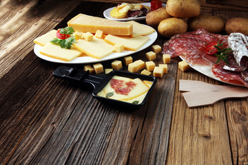 Delicious traditional Swiss melted raclette cheese on diced boiled or baked potato.