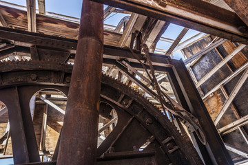 industrial mining equipment decomposing inside wood enclosure